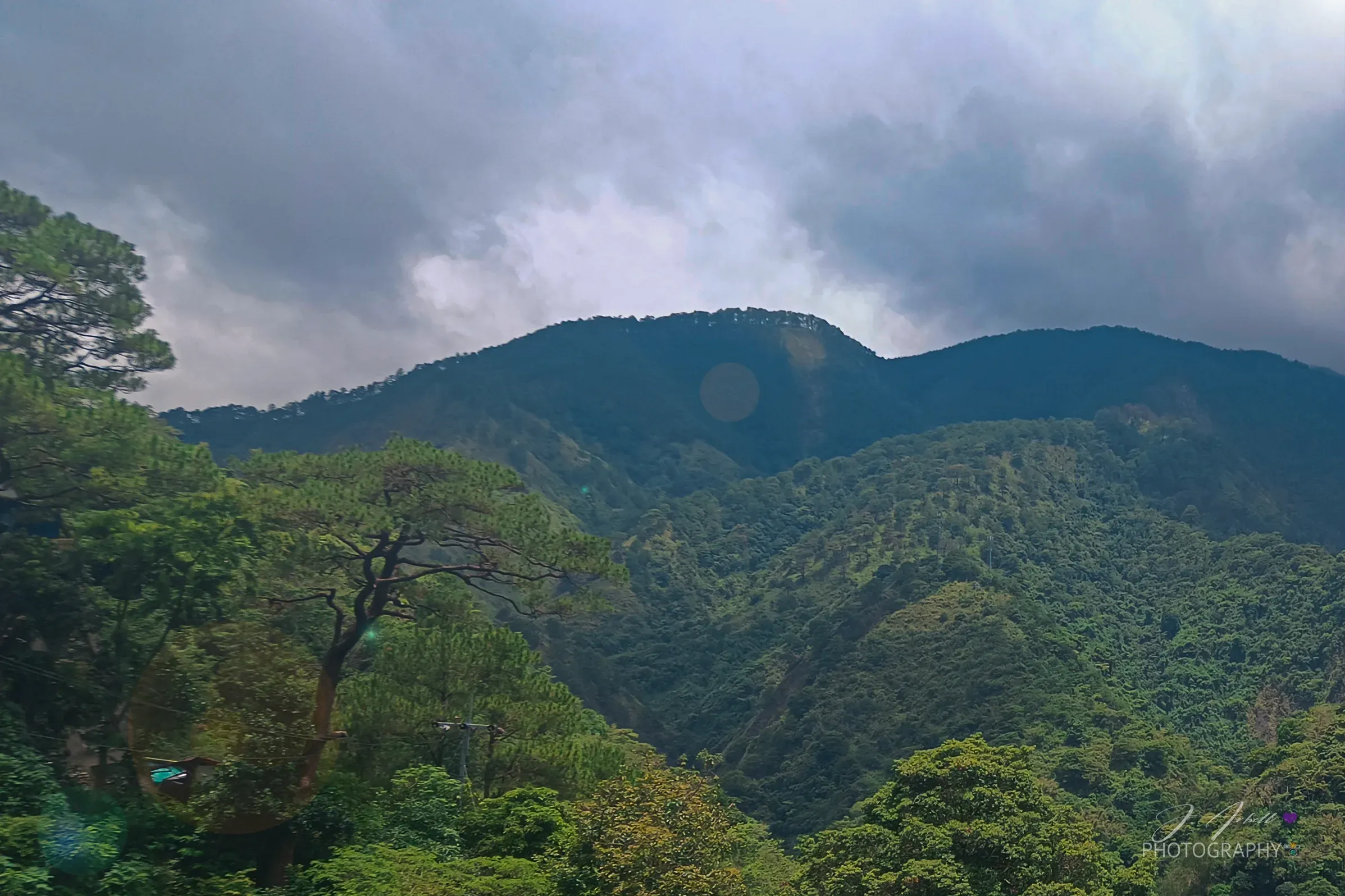 Forested mountain ridges along Kennon Road under low cloud on the climb to Baguio