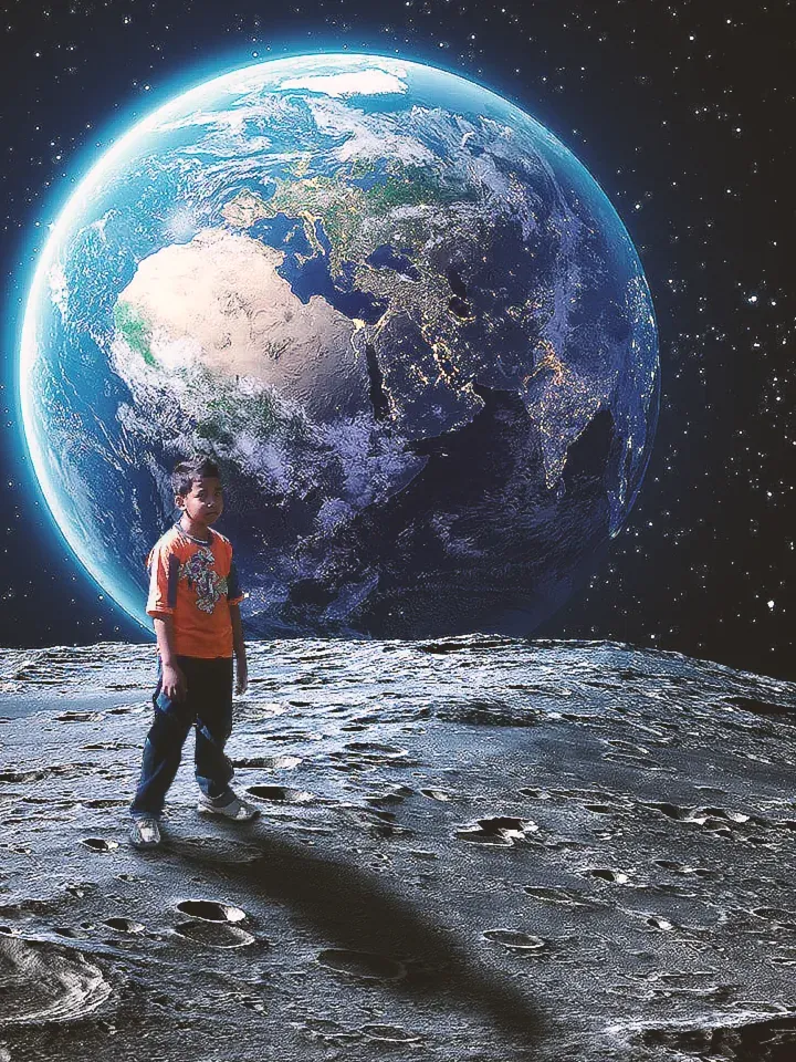 Composite of a boy in an orange shirt standing on the cratered surface of the moon, Earth rising in the starfield behind him